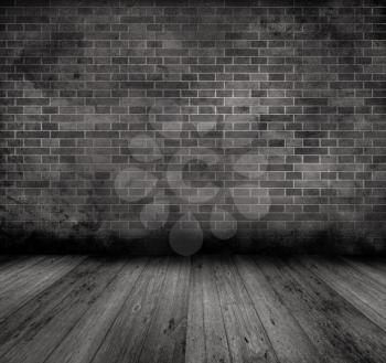 Grunge style image of an old interior with brick wall and wooden floor