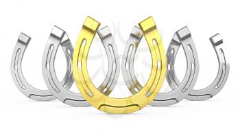 Gold horseshoe between gray ones, isolated on white background