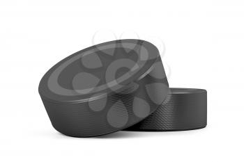 Two ice hockey pucks on white background