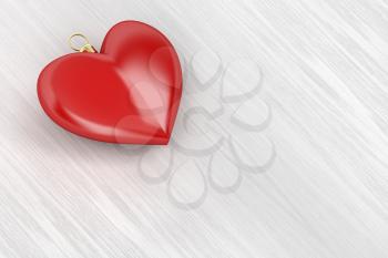 Heart shaped Christmas ball on wood background