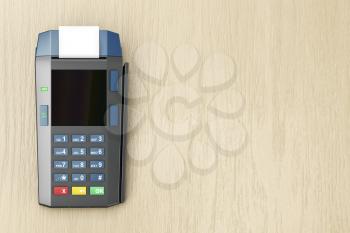 Credit card terminal on wooden desk, top view