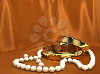 Two gold rings over red silk background