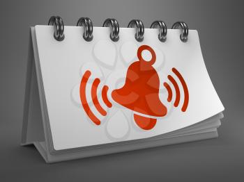 White Desktop Calendar with Red Ringing Bell Icon on Gray Background.
