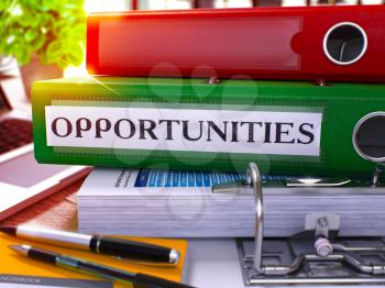 Opportunities - Green Office Folder on Background of Working Table with Stationery and Laptop. Opportunities Business Concept on Blurred Background. Opportunities Toned Image. 3D