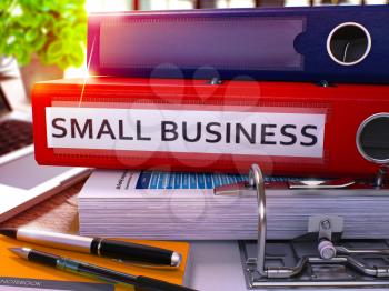 Small Business - Red Office Folder on Background of Working Table with Stationery and Laptop. Small Business Business Concept on Blurred Background. Small Business Toned Image. 3D.