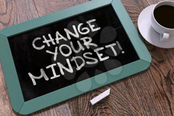 Change Your Mindset Handwritten on Blue Chalkboard. Business Concept. Composition with Chalkboard and Cup of Coffee. Top View Image. 3D Render.