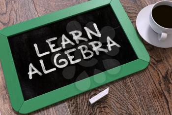 Learn Algebra Concept Hand Drawn on Green Chalkboard on Wooden Table. Business Background. Top View. 3D Render.