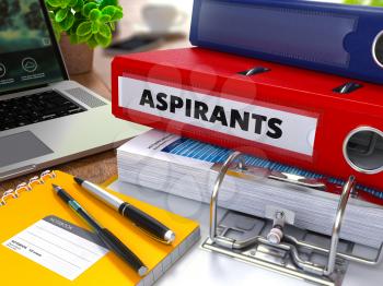 Red Ring Binder with Inscription Aspirants on Background of Working Table with Office Supplies, Laptop, Reports. Toned Illustration. Business Concept on Blurred Background. 3D Render.