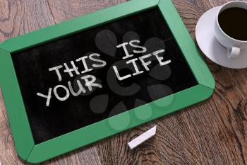 Handwritten This is Your Life on a Green Chalkboard. Top View Composition with Chalkboard and White Cup of Coffee. 3D Render.