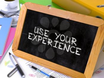 Hand Drawn Use Your Experience Concept  on Chalkboard. Blurred Background. Toned Image. 3D Render.