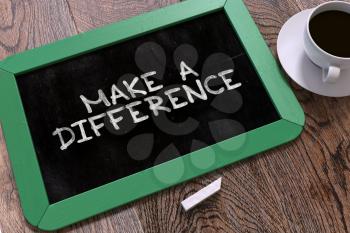 Make a Difference Handwritten by White Chalk on a Blackboard. Composition with Small Green Chalkboard and Cup of Coffee. Top View. 3D Render.