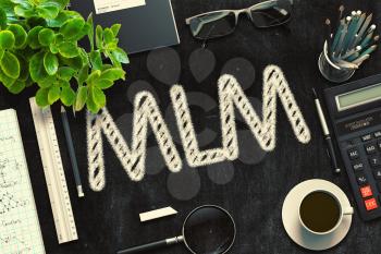 MLM - Text on Black Chalkboard.3d Rendering. Toned Illustration.