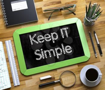 Top View of Office Desk with Stationery and Green Small Chalkboard with Business Concept - Keep IT Simple. Keep IT Simple - Text on Small Chalkboard.3d Rendering.