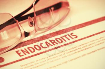 Endocarditis - Printed Diagnosis on Red Background and Specs Lying on It. Medical Concept. Blurred Image. 3D Rendering.