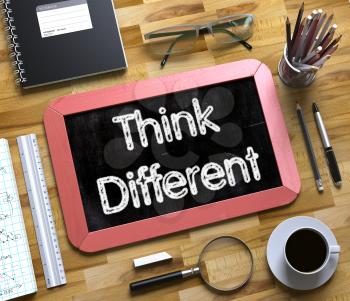Think Different - Red Small Chalkboard with Hand Drawn Text and Stationery on Office Desk. Top View. Think Different Handwritten on Small Chalkboard. 3d Rendering.