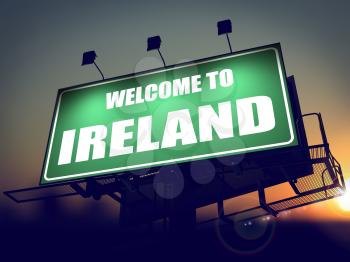 Welcome to Ireland - Green Billboard on the Rising Sun Background.