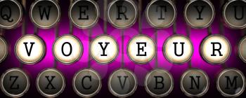 Voyeur on Old Typewriter's Keys on Blue Background.