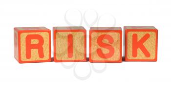 Risk on Wooden Childrens Alphabet Block Isolated on White.