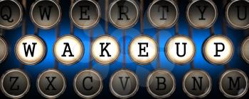 Wake Up - Word on Old Typewriter's Keys on Blue Background.