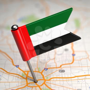 Small Flag of United Arab Emirates Sticked in the Map Background with Selective Focus.