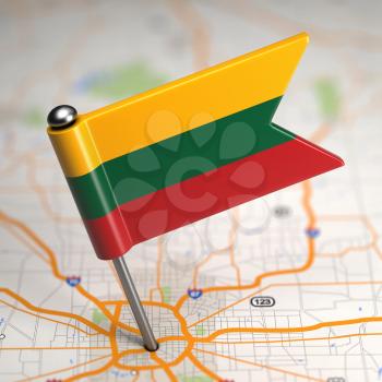 Small Flag of Lithuania Sticked in the Map Background with Selective Focus.