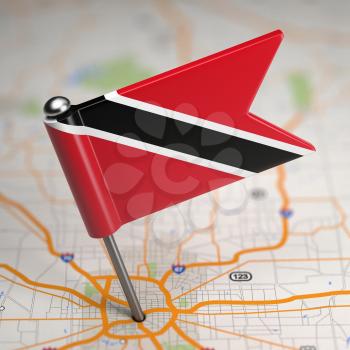 Small Flag Republic of Trinidad and Tobago on a Map Background with Selective Focus.