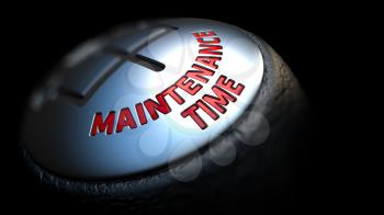 Gear Stick with Red Text Maintenance Time on Black Background. Close Up View. Selective Focus. Control Concept.