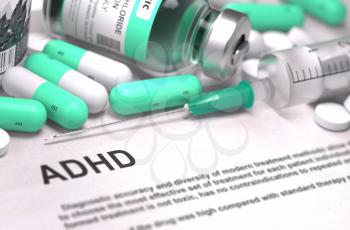 ADHD - Printed Diagnosis with Blurred Text. On Background of Medicaments Composition - Mint Green Pills, Injections and Syringe.