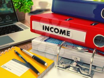 Red Office Folder with Inscription Income on Office Desktop with Office Supplies and Modern Laptop. Business Concept on Blurred Background. Toned Image.