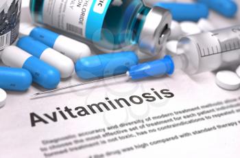 Avitaminosis - Printed Diagnosis with Blue Pills, Injections and Syringe. Medical Concept with Selective Focus.