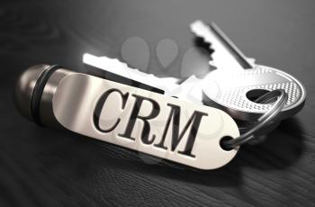 CRM - Customer Relationship Management - Concept. Keys with Keyring on Black Wooden Table. Closeup View, Selective Focus, 3D Render. Black and White Image.