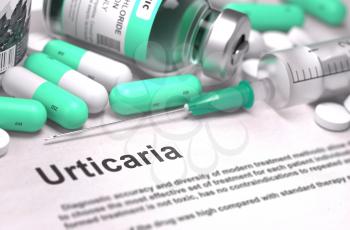 Diagnosis - Urticaria. Medical Report with Composition of Medicaments - Light Green Pills, Injections and Syringe. Blurred Background with Selective Focus.