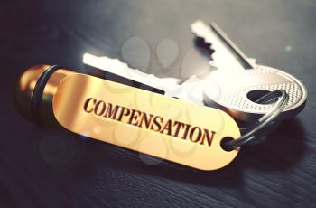 Keys with Word Compensation on Golden Label over Black Wooden Background. Closeup View, Selective Focus, 3D Render. Toned Image.