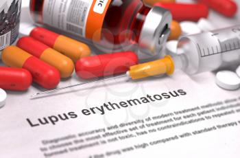 Lupus Erythematosus - Printed Diagnosis with Blurred Text. On Background of Medicaments Composition - Red Pills, Injections and Syringe.