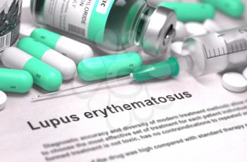 Lupus Erythematosus - Printed Diagnosis with Blurred Text. On Background of Medicaments Composition - Mint Green Pills, Injections and Syringe.