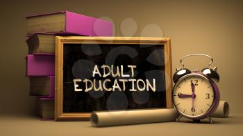 Handwritten Adult Education on a Chalkboard. Composition with Chalkboard and Stack of Books, Alarm Clock and Rolls of Paper on Blurred Background. Toned Image.