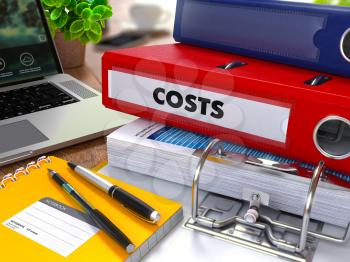 Red Ring Binder with Inscription Costs on Background of Working Table with Office Supplies, Laptop, Reports. Toned Illustration. Business Concept on Blurred Background.