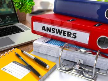 Red Ring Binder with Inscription Answers on Background of Working Table with Office Supplies, Laptop, Reports. Toned Illustration. Business Concept on Blurred Background.