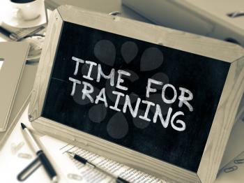 Time for Training. Inspirational Quote Hand Drawn on Chalkboard on Working Table Background. Blurred Background. Toned Image.