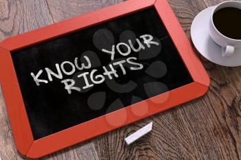 Know Your Rights Handwritten by white Chalk on a Blackboard. Composition with Small Red Chalkboard and Cup of Coffee. Top View.