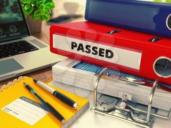 Red Office Folder with Inscription Passed on Office Desktop with Office Supplies and Modern Laptop. Business Concept on Blurred Background. Toned Image.