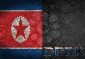 Old rusty metal sign with a flag and country abbreviation - North Korea