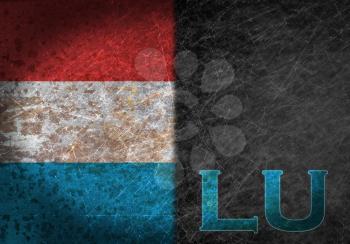 Old rusty metal sign with a flag and country abbreviation - Luxembourg