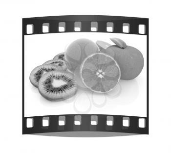 slices of kiwi, apple, orange and half orange on a white. The film strip