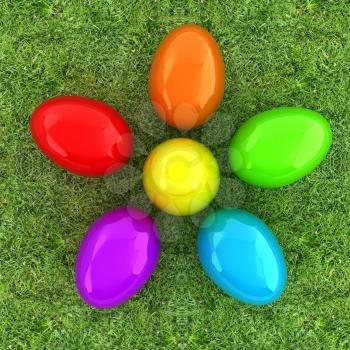 Colored Easter eggs as a flower on a green grass