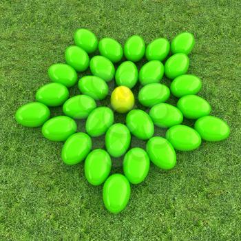 Colored Easter eggs as a flower on a green grass