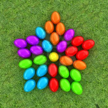 Colored Easter eggs as a flower on a green grass