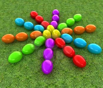 Colored Easter eggs as a flower on a green grass