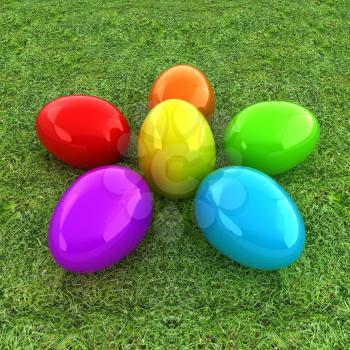 Colored Easter eggs as a flower on a green grass