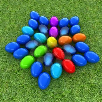 Colored Easter eggs as a flower on a green grass